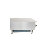 A modern and industrial countertop charbroiler, crafted from stainless steel, is shown from the side. It features four short cylindrical legs, a control knob on the right, and a flat top surface—ideal for heavy-duty kitchen use.