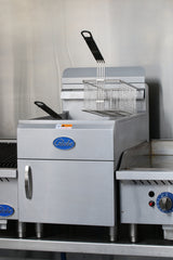 A commercial 30-lbs fat capacity stainless steel fryer with a rectangular frying basket and black handle. The blue Globe logo is displayed on the front, and this gas countertop fryer sits among other kitchen appliances.