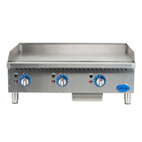 A commercial 36 inch countertop griddle with three blue control knobs, indicator lights, tall legs, a grease tray, and a backsplash. The front panel features ventilation slots and a Globe brand logo on the lower right corner.