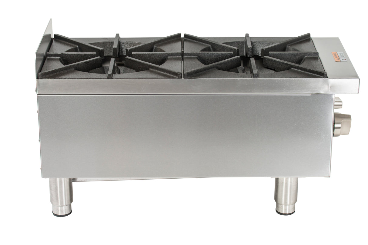 A stainless steel commercial gas countertop stove with two large cast iron burners and sturdy black grates, viewed from the front and slightly above. The stove features heavy-duty metal legs and control knobs on the front right side.