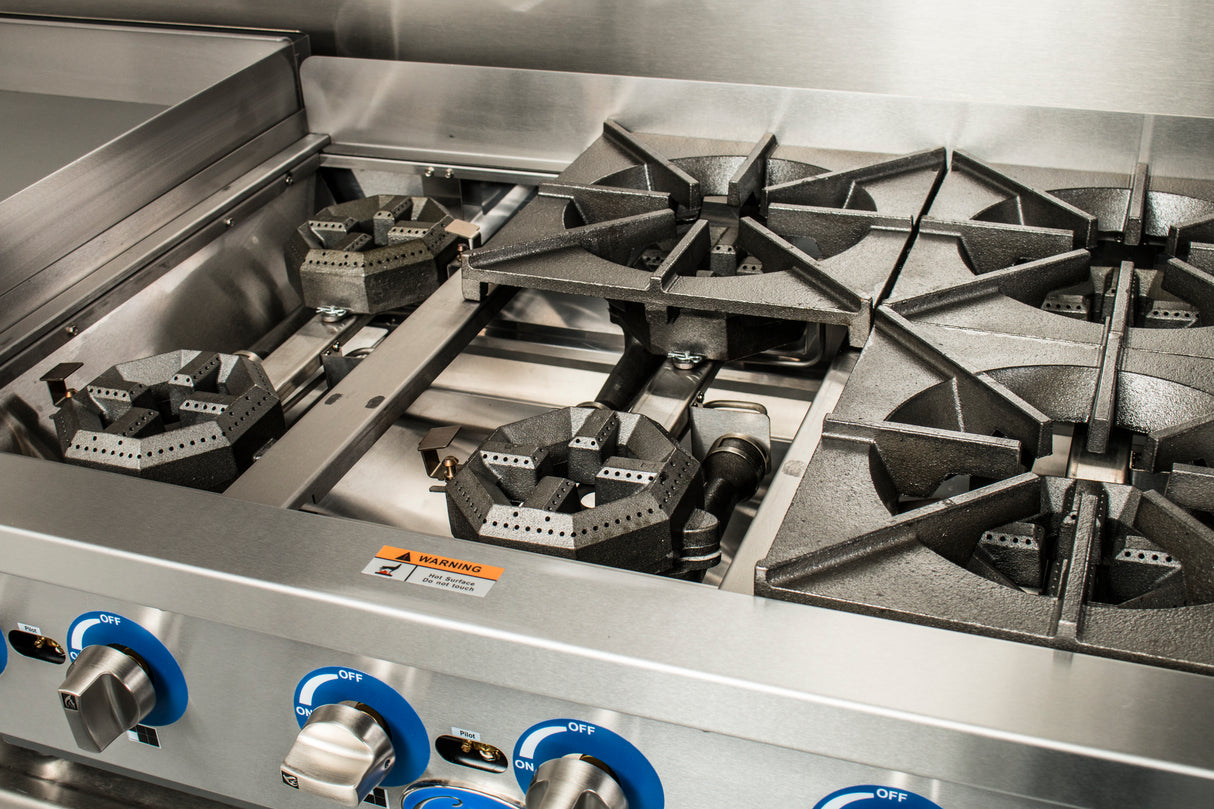 Close-up of a Globe GHP36G commercial 6 burner hotplate with heavy-duty cast iron burners, blue control knobs, and a warning label. The clean, modern gas countertop hotplate is unused in a professional kitchen environment.