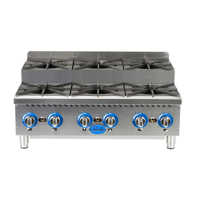 A commercial stainless steel gas countertop hotplate with six burners, each featuring a black cast iron grate and blue control knob. The front panel displays the Globe logo, and the 36 inch hotplate stands on four sturdy metallic legs.
