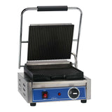 A commercial panini press with a stainless steel body, ribbed black cast iron grooved plates, and a large handle. The blue front panel features a red power switch, indicator light, and round temperature dial. The open panini grill displays both grill plates.