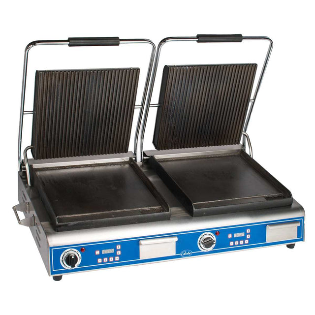 A double countertop grill featuring two hinged, ribbed cast iron plates on top and flat bottoms, each with a handle. The metallic silver base has a blue panel with control knobs, switches, and indicator lights for each sandwich panini grill side.