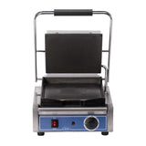 A stainless steel Bistro Panini Grill with a blue front panel, red power switch, round temperature dial, and indicator light. The top grill plate is lifted, revealing ridged nonstick plates—perfect as a countertop electric grill for sandwiches or paninis.