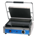 A commercial sandwich grill with a stainless steel exterior, black nonstick grill plates, and a handle. The hinged top plate is open, revealing the blue control panel with an ON/OFF switch and temperature dial. The press sits on black feet.
