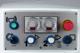 Close-up of a spiral dough mixer control panel with two dials, red emergency stop button, green start button with steering wheel icon, blue reverse and stop buttons, blue speed buttons labeled 1 and 2—all set on a metallic surface near the 130 lbs capacity stainless steel bowl.