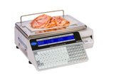 A digital label printing scale displays weights and prices on a dual-sided LCD display in blue numbers. Thin slices of deli meat rest on the tray, while a small receipt is printed from the side. This model is legal for trade.