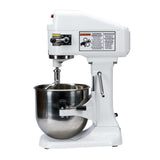 A commercial 8 qt mixer with a large stainless steel mixing bowl and flat beater attachment. Warning and instruction labels are visible on the upper body. This sturdy countertop mixer features an industrial, planetary design.