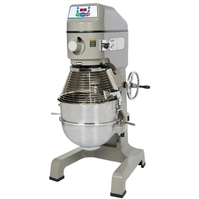 A large commercial floor mixer with a digital control panel, metal body, safety guard, and a stainless steel mixing bowl attached at the base. The planetary mixer has sturdy legs and a side hand crank for bowl adjustment.