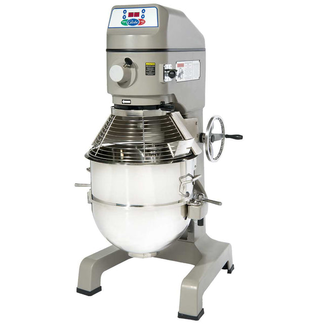 A large, industrial commercial floor mixer with a stainless steel mixing bowl, protective wire guard, control panel at the top, and a side crank handle. This gray planetary mixer is designed for heavy-duty food preparation.