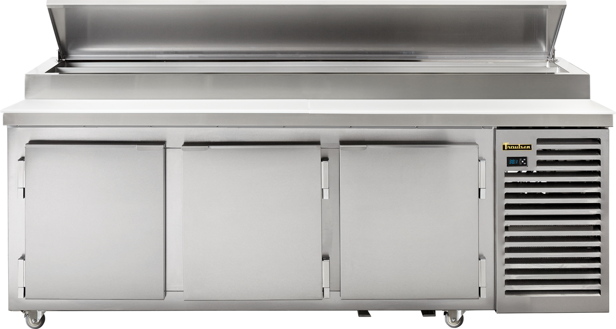 The BLU 3-Row Glycol Prep Table is a large commercial stainless steel prep table featuring self-contained refrigeration, three lower cabinet doors, a flat working surface, raised back ledge, ventilation grills, wheels, and a digital temperature display.