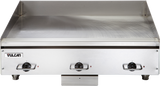 A heavy duty electric countertop griddle with a 36 inch flat stainless steel cooking surface, three control knobs with indicator lights, and the Vulcan logo on the front left. Raised edges help contain food. The background is plain white.