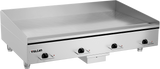 A large heavy duty griddle with four black control knobs on the front, labeled Vulcan. The flat polished steel griddle plate has raised back and sides. Four short legs support the unit, with a small drawer beneath the center.