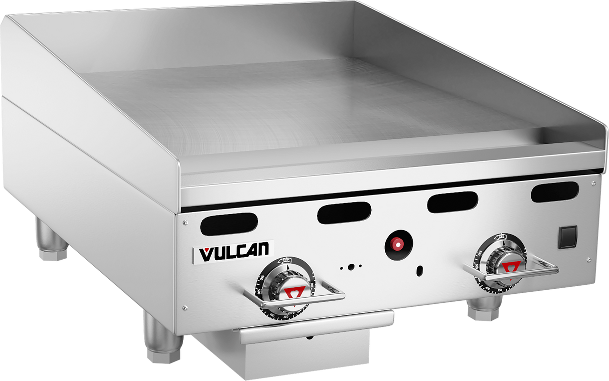 A heavy duty Vulcan 24" gas countertop griddle with two control knobs, a flat stainless steel cooking surface, short legs, and a grease tray underneath. The front panel displays the Vulcan logo and indicator lights.