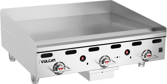 A stainless steel Heavy Duty Griddle with three red-and-silver control knobs, black air vents, raised sides, and the Vulcan logo on the front left. This 36" countertop gas griddle features a smooth flat cooking surface and sits on four short legs.