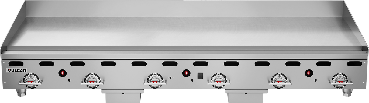 A large, heavy duty griddle with five control knobs, ventilation slots, and indicator lights on the front. This 72 inch gas countertop griddle features a flat, spacious cooking surface with raised edges. The brand name Vulcan appears on the lower left.