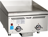 A stainless steel Vulcan Heavy Duty Griddle with two control knobs, vent slots, an Energy Star sticker, and a flat cooking surface. This countertop gas griddle sits on four short legs and features raised back and side panels for splash protection.