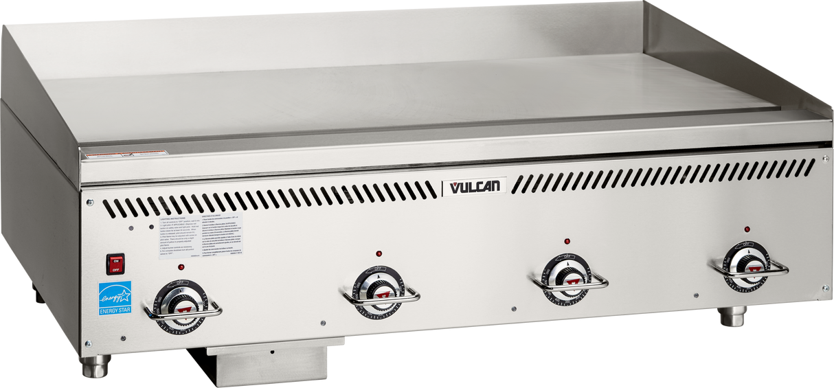 A Vulcan Heavy Duty Griddle with three temperature control knobs, a flat cooking surface, and a blue energy certification sticker. This countertop gas griddle features durable stainless steel construction and advanced infrared burner technology for even heating.