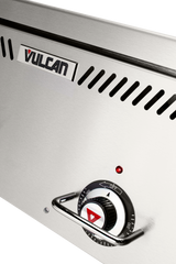 Close-up of a stainless steel Vulcan Heavy Duty Griddle. The image highlights a control dial with temperature markings, a red triangular indicator, and an OFF label. Above the dial are a small red indicator light and black vent slots.