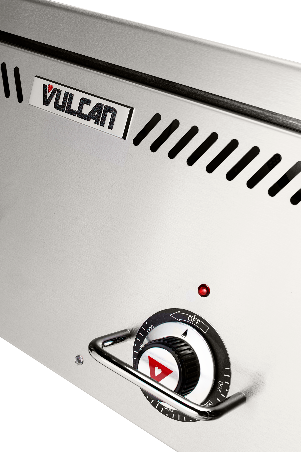 Close-up of a stainless steel Vulcan VCCG60-IC_LP gas countertop griddle with a logo at the top, a black temperature control dial featuring a red triangle, an indicator light above the dial, and angled ventilation slits. Background is white.