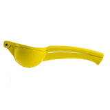A bright yellow citrus hand squeezer with two elongated handles and a rounded, bowl-shaped chamber for pressing fruit, shown in a side profile on a plain white background. Crafted from coated zinc alloy for durability.