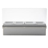 A stainless steel bar caddy set featuring four rectangular white compartments and a clear plastic sneeze guard attached at the back, viewed from the front on a plain white background.