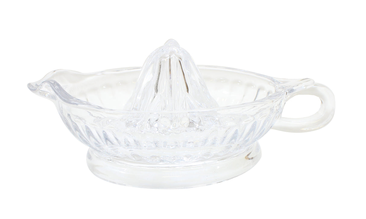 Clear glass TableCraft juicer with a central reamer, a spouted edge for pouring, and a side handle for gripping. Its sturdy round base features ridged detailing along the sides for decoration. The glass juicer is empty and clean.