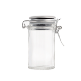 A clear empty glass jar with a stainless steel clip top lid and rubber seal, photographed against a white background. The cylindrical jar’s clasp is slightly open, similar to those found on premium glass shakers or salt and pepper shakers.