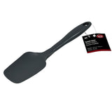 A black BPA free silicone spatula spoon with a wide, flat head and curved handle. A tag attached to the handle displays product information in English and Spanish. The heat resistant spatula rests on a plain white background.
