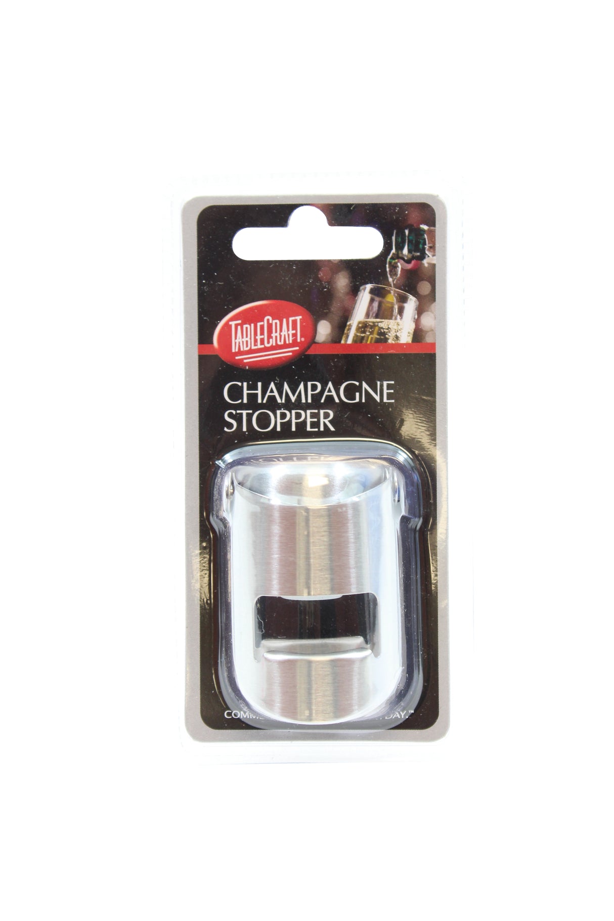 A stainless steel Champagne bottle sealer is sealed in its original black and clear plastic packaging. The label reads TableCraft Champagne Stopper and shows a champagne bottle in the background. The packaging hangs against a plain white background.