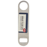A stainless steel flat bottle opener with a circular hole at one end and a bottle-opening slot at the other. This pocket bottle opener is dishwasher safe, with a navy label reading “Bartender’s Friend™ Flat Bottle Opener, Stainless Steel, 7 1/8 in., TableCraft.”.