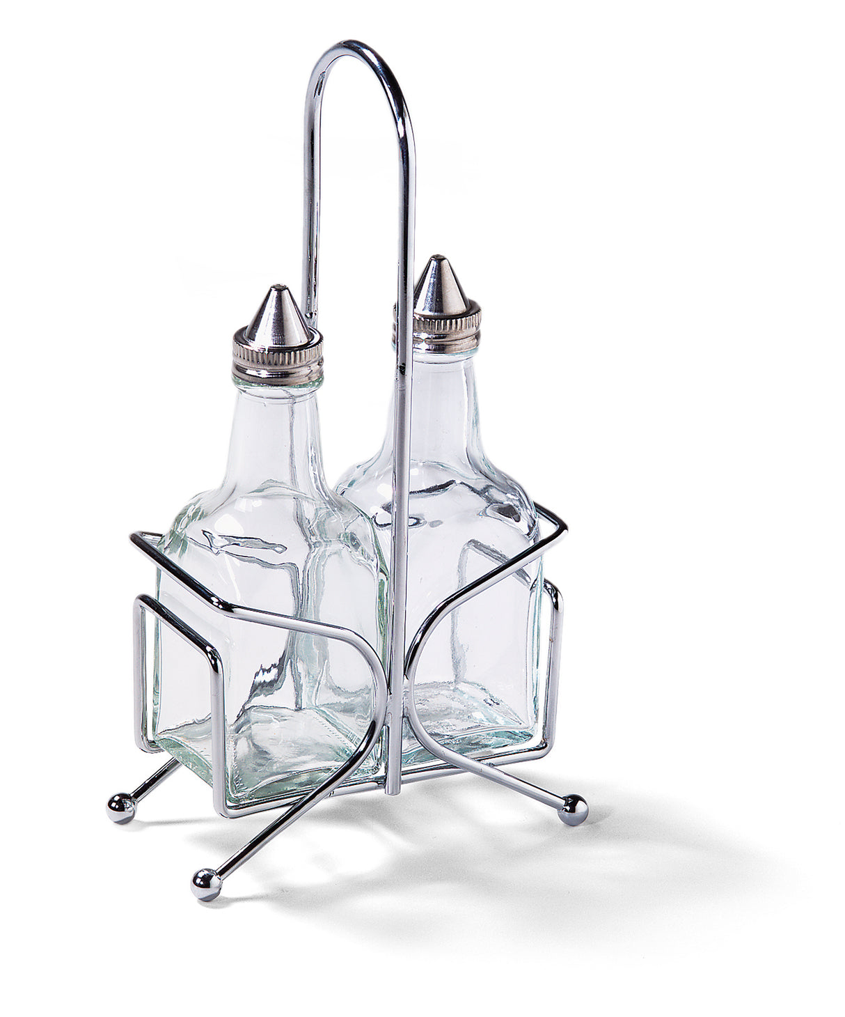 Two clear glass bottles with metal spouts sit in a silver metal stand. Perfect as an Oil & Vinegar Dispenser Set from TableCraft, the stand features four ball feet and a tall handle, keeping the square-shaped bottles upright on any Cash & Carry display.