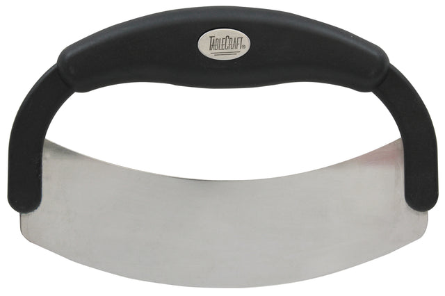 A handheld mezzaluna food cutter with a curved stainless steel blade and black ergonomic handle, designed for easy rocking motion to chop herbs or vegetables. The handle features a metallic oval label with the brand name TableCraft.