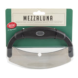 A handheld mezzaluna food cutter with a curved stainless steel blade and black plastic handle, displayed in packaging labeled “MEZZALUNA.” The ergonomic design measures 7.5 x 5 x 1.27 cm. Brand: TableCraft.