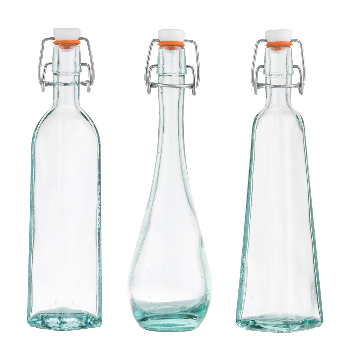 Three empty TableCraft resealable bottles with metal swing-top lids and orange rubber seals, each uniquely shaped—square, rounded with a tapered middle, and rectangular. Made from transparent recycled glass, all stand upright on a white background.
