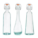 Three empty TableCraft resealable bottles with metal swing-top lids and orange rubber seals, each uniquely shaped—square, rounded with a tapered middle, and rectangular. Made from transparent recycled glass, all stand upright on a white background.