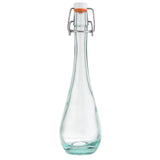 A clear TableCraft glass bottle with a long, narrow neck and round base. Featuring an orange rubber gasket and white ceramic stopper, this resealable bottle is secured with a metal wire clasp. The empty bottle is photographed on a white background.