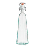 A clear, tall TableCraft resealable bottle with a square base, slightly tapering towards the neck. Made from green tint glass, it features a metal swing top closure with a white ceramic cap and orange gasket to securely seal the contents. The bottle is empty.