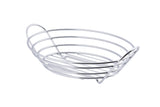 A chrome plated metal wire serving basket with an open, oval shape and parallel horizontal bars forming the sides and base. The TableCraft basket features two integrated handles on each end and small feet underneath for a slightly elevated stance.
