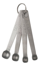 A set of four metal measuring spoons on a keyring labeled “TAD,” “DASH,” “PINCH,” and “SMIDGEN” fanned out beside a J.A. Henckels Steel sharpening steel, perfect for precise ingredient measurements and maintaining sharp blades.