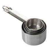 A stainless steel measuring cup set of four nested cups, held together by a metal ring. The handles are marked with measurements, with 1/4 cup 60 ml visible on top. Durable and dishwasher safe for easy cleaning.