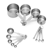 The image shows a stainless steel measuring set, featuring two sets of measuring cups and spoons joined by metal rings. Each utensil is labeled with precise measurements and arranged neatly on a white background.