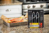 A Seafood Kit featuring lobster crackers and fork picks is displayed on a granite kitchen counter. In the background, a tray of crab legs with lemon wedges sits near a stainless steel stove. The package reads “Seafood Set.”.