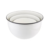 Three white Enamelware mixing bowls of different sizes are stacked inside each other. Each bowl has a thin black rim and glossy finish, giving them a clean, modern look. Made from porcelain enamel coated steel, they are also dishwasher safe.
