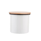 A white cylindrical enamelware canister with smooth sides and a flat, light-colored bamboo lid. This minimalist container is photographed against a plain white background, making it a stylish addition to any enamelware canister set.