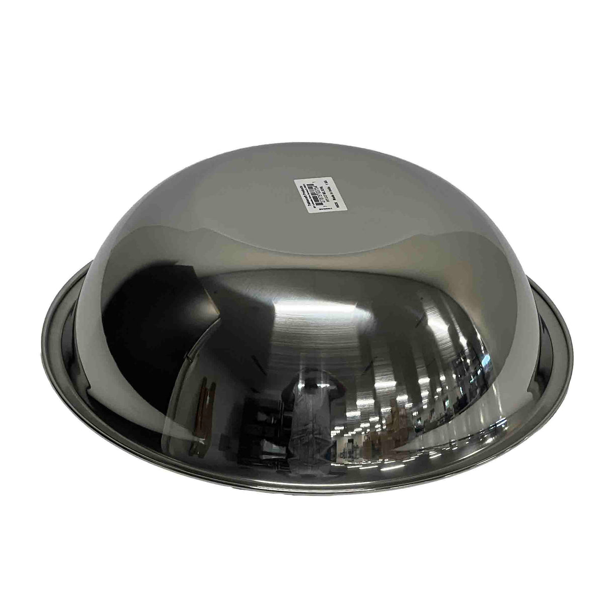 A shiny 5 qt stainless steel mixing bowl is placed upside down on a white surface. The bowl features a smooth, reflective finish with a barcode sticker at the top center and reflects lights and shelves on its surface.