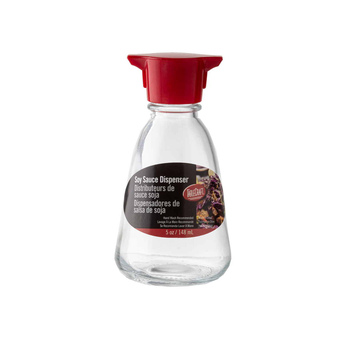 A TableCraft glass soy sauce dispenser with a red plastic lid features a label reading “Soy Sauce Dispenser” in English and Spanish, plus a sushi photo. This soy sauce bottle holds 5 oz (148 mL). The background is plain white.