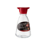 The TableCraft glass soy sauce dispenser features a red plastic cap and spout. Its label—marked in English, French, and Spanish—shows a small food image and notes a 5 oz (148 ml) capacity. Perfect as an elegant soy sauce bottle for the table.