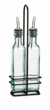 Two green tint glass bottles with stainless steel pourers sit side by side in a chrome plated rack with a handle. The square bottles are often used for oil and vinegar on kitchen tables, adding both function and style to your dining experience.